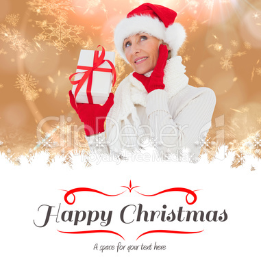 Composite image of festive woman holding gift