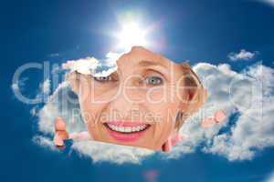 Composite image of older woman looking through rip