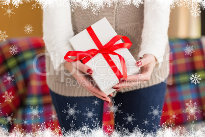 Composite image of woman with nail varnish holding gift