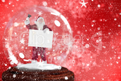 Santa ringing bell and holding sign in snow globe