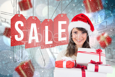 Composite image of attractive woman wearing santa hat with gifts