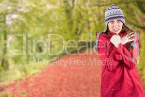 Composite image of cold redhead wearing coat and hat