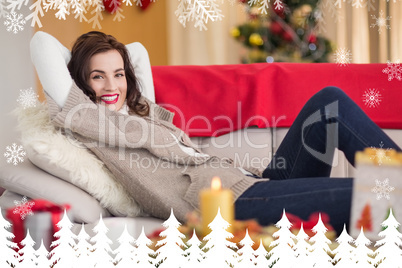 Composite image of smiling brunette relaxing on the couch at chr