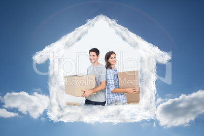 Composite image of wife and husband carrying boxes