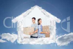 Composite image of wife and husband carrying boxes