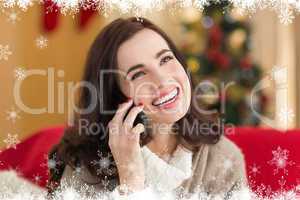 Composite image of smiling brunette on the phone on christmas da