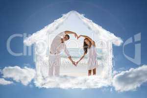 Composite image of romantic couple forming heart shape with arms