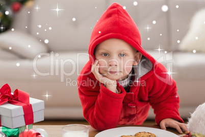 Composite image of festive little boy smiling at camera