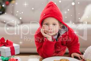 Composite image of festive little boy smiling at camera