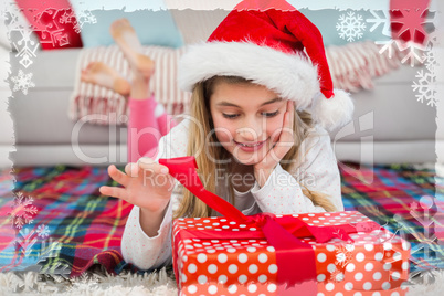 Composite image of festive little girl opening a gift