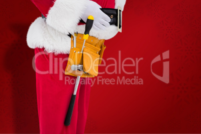 Composite image of santa claus with tool belt