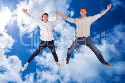 Composite image of couple jumping and holding hands