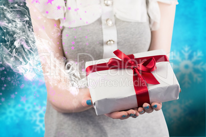 Composite image of woman offering a wrapped gift