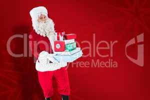 Composite image of father christmas holding many gifts