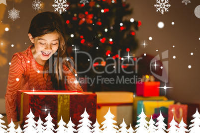 Composite image of little girl opening a glowing christmas gift