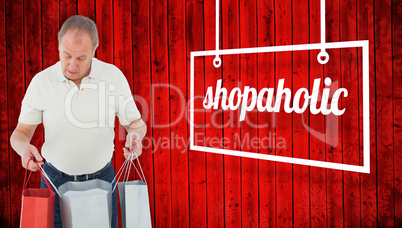 Composite image of man looking in shopping bags