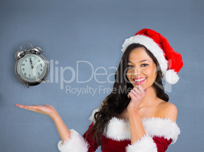 Composite image of pretty girl presenting in santa outfit