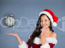 Composite image of pretty girl presenting in santa outfit
