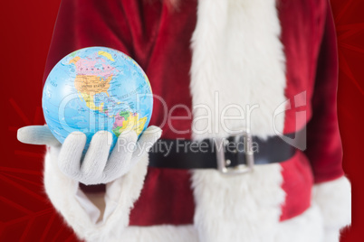 Composite image of santa has a globe in his hand