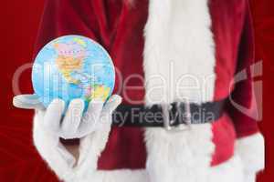 Composite image of santa has a globe in his hand