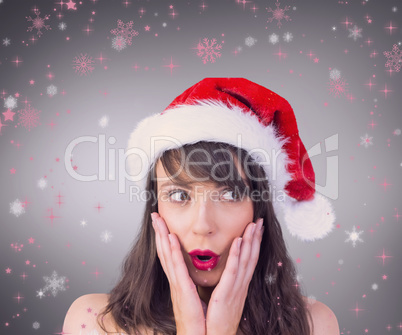 Composite image of festive brunette looking surprised with hands