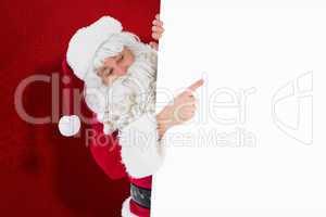 Composite image of festive father christmas presenting sign