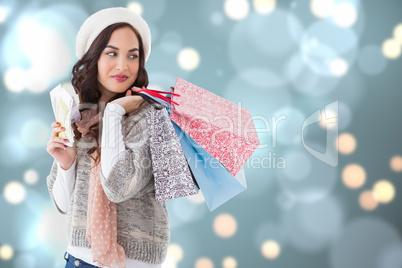 Composite image of brunette holding cash and shopping bags