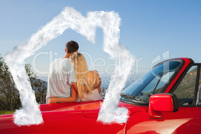 Composite image of rear view of couple hugging and admiring pano