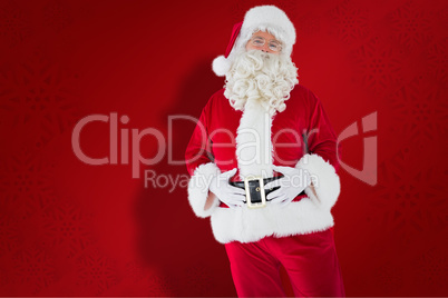 Composite image of santa claus holding his belly