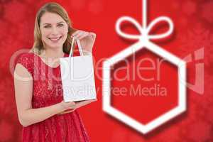 Composite image of pretty blonde in red dress holding a shopping