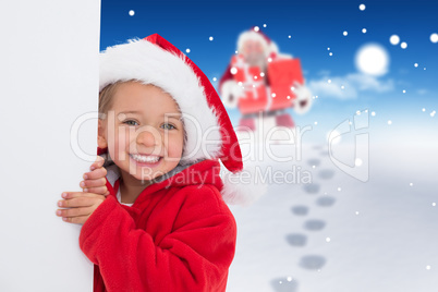 Composite image of festive little girl showing poster Composite image of festive little girl showing poster