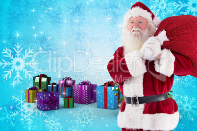 Composite image of santa carries his red bag and smiles