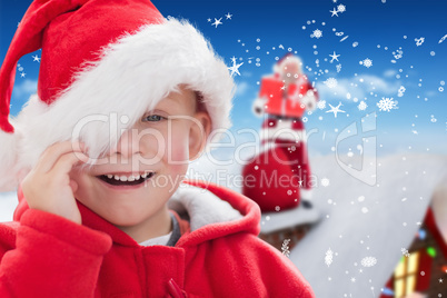 Composite image of cute boy in santa hat