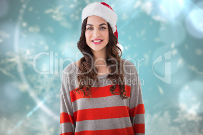 Composite image of beautiful brunette in santa hat smiling at ca