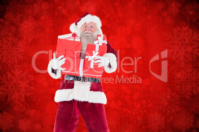 Composite image of santa carries a few presents