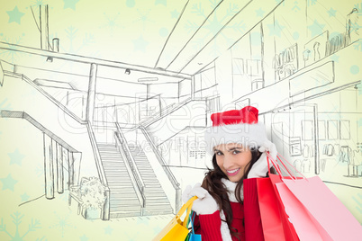 Composite image of festive brunette in winter wear holding shopp