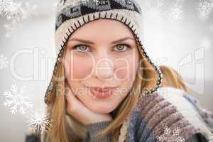 Composite image of close up of a woman in winter hat looking at