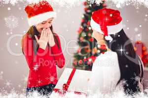 Composite image of mother giving her daughter a christmas presen