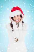 Composite image of festive brunette smiling at camera