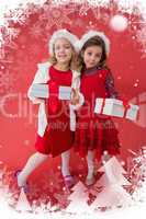 Composite image of festive little girls smiling at camera with gifts