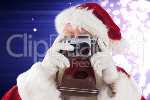 Composite image of santa is taking a picture