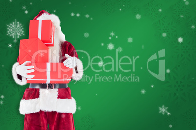 Composite image of santa covers his face with presents