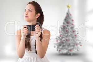 Composite image of thoughtful brunette holding her phone