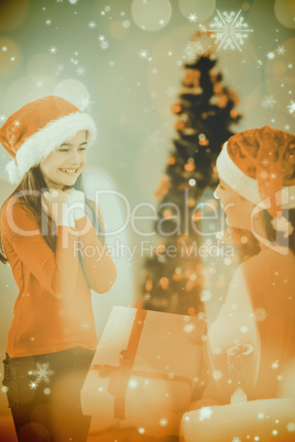 Composite image of mother giving her daughter a christmas presen