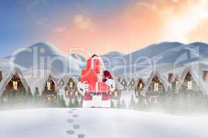 Composite image of santa carrying gifts in the snow