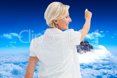 Composite image of happy mature woman writing and smiling