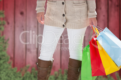 Composite image of woman with shopping bags