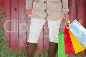 Composite image of woman with shopping bags