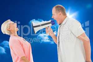 Composite image of man shouting at his partner through megaphone