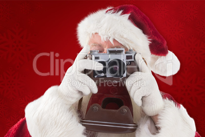 Composite image of santa is taking a picture